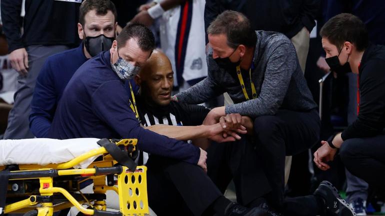 Bert Smith Referee being attending to during Elite 8 NCAA March Madness Game - courtesy of Getty Images