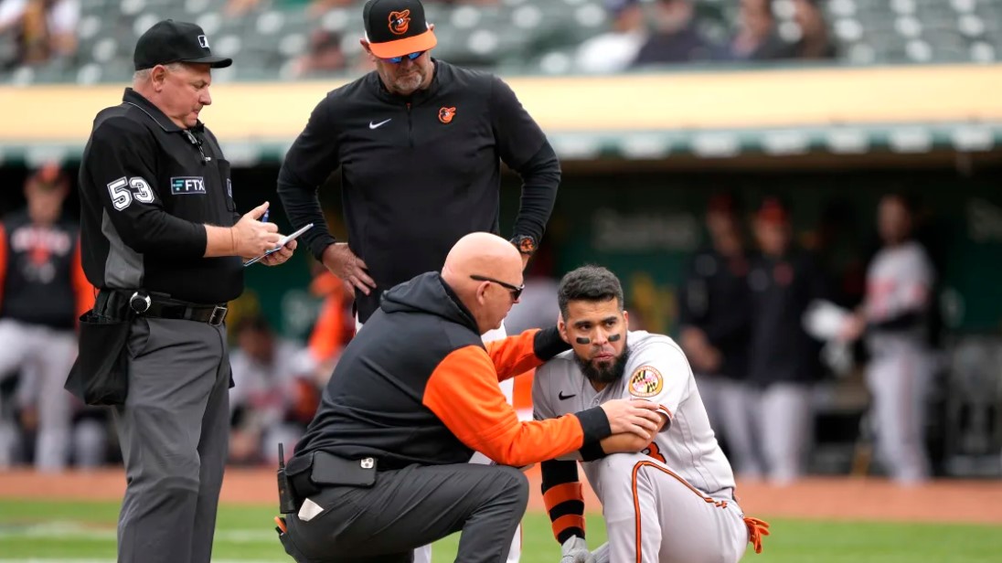 Baltimore Orioles v Oakland Athletics: Athletic trainer Brian Ebel checks on an injured player / Thearon W. Henderson/GettyImages