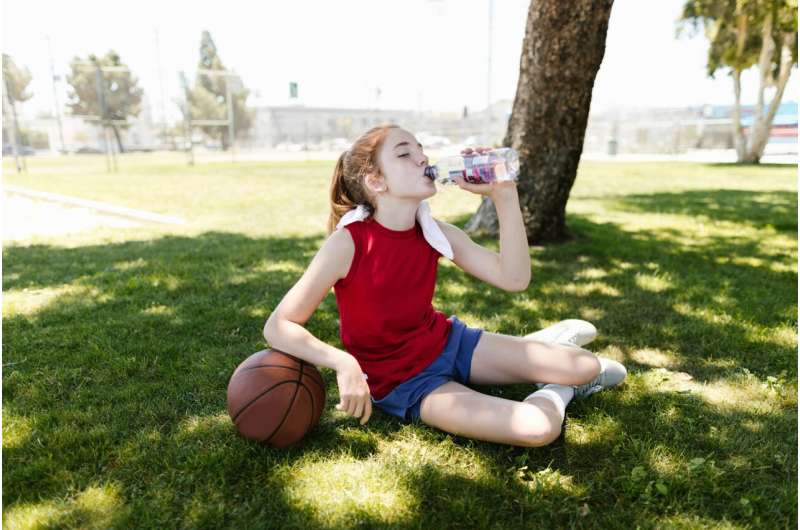 Young Athlete Drinking Water
