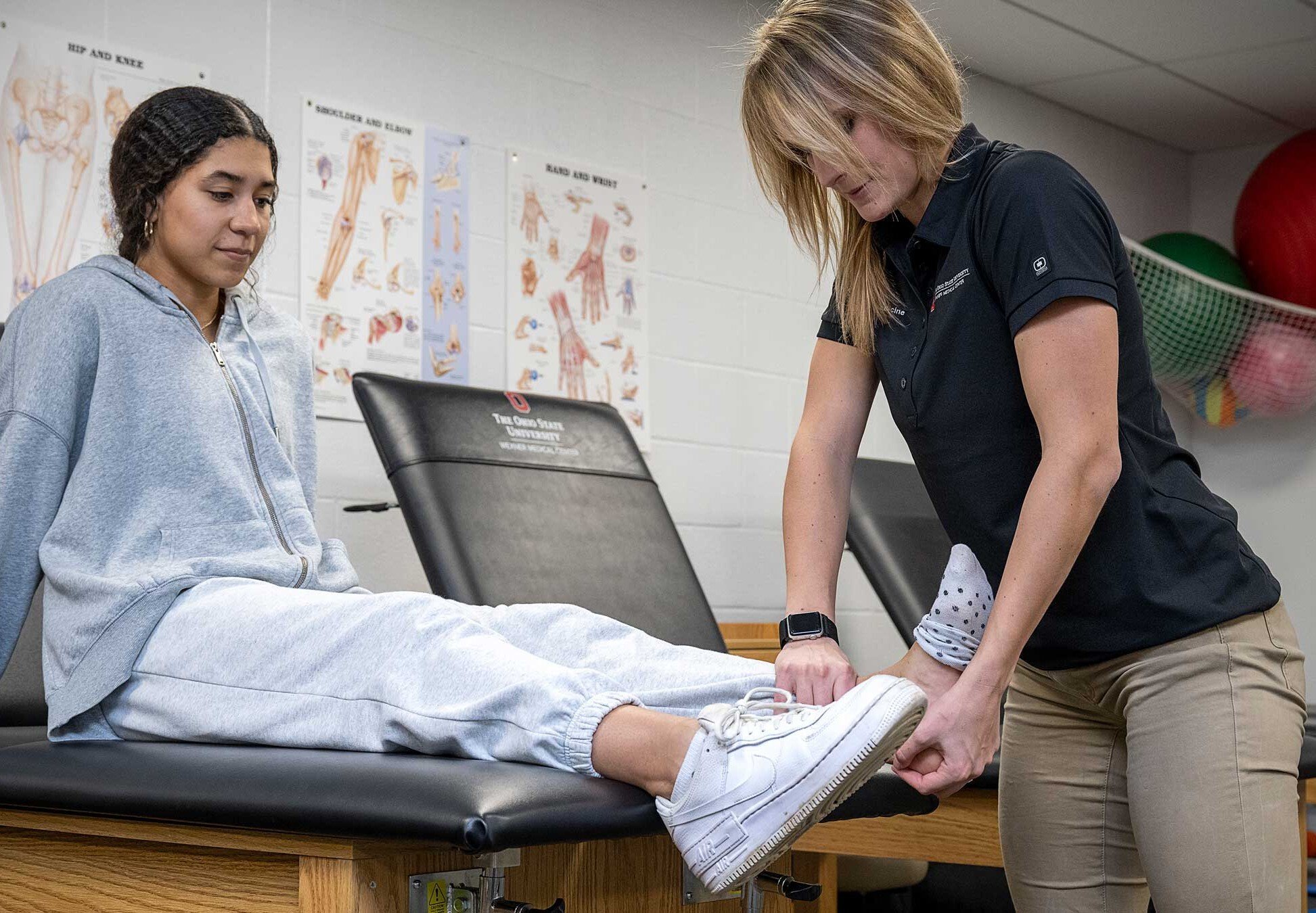 Megan Giesige, MS, AT, examines a student athlete’s ankle to test ankle mobility.